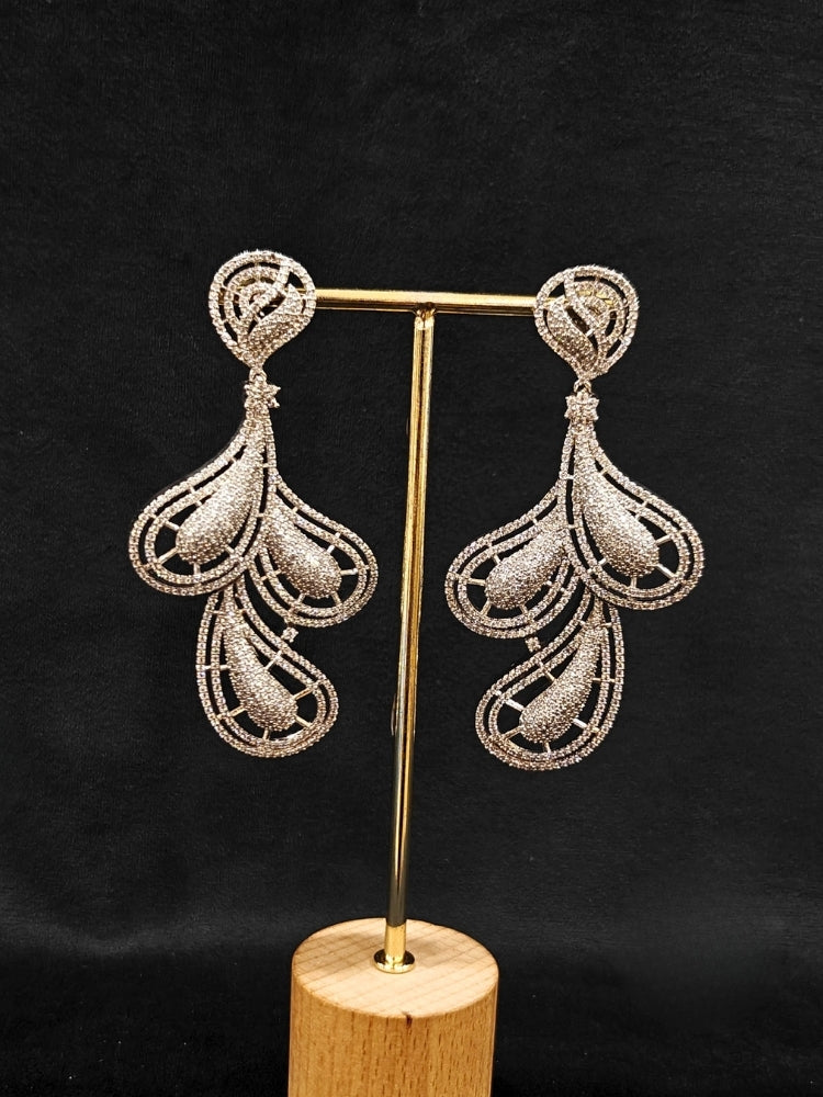 Close-up of an ornate Western American Diamond Silver Earrings with American Diamond. Elegant party wear styled with high-quality imitation American Diamond earrings. Close-up of American diamond earrings styled for a reception party.