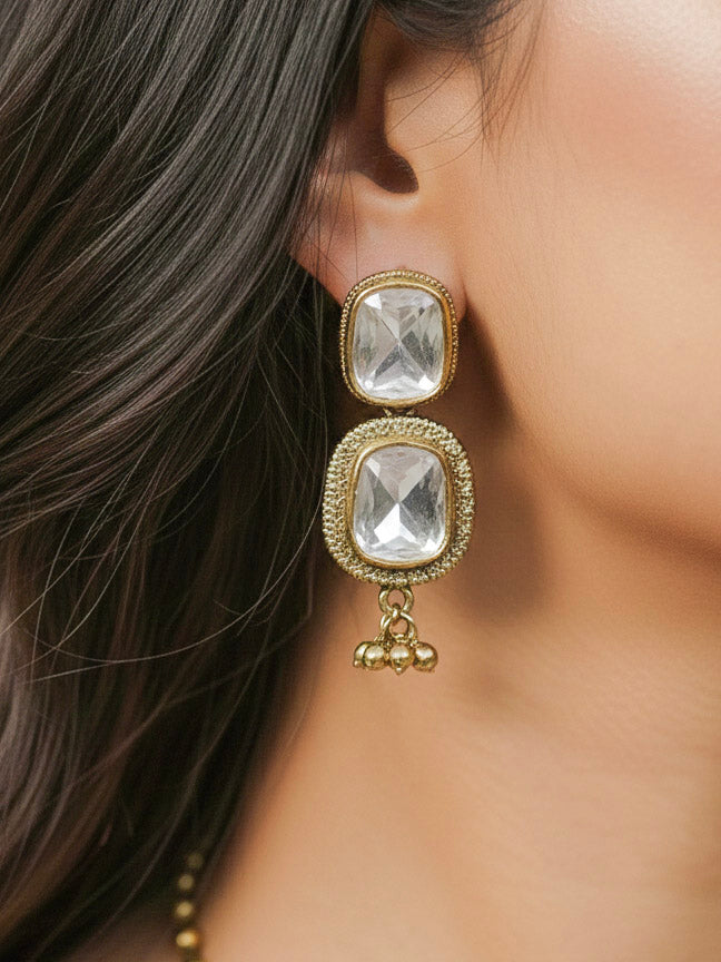 Close-up of a woman wearing an ornate Indo-western (Mehendi Polish Antique Finish) Long jewellery set and earrings American Diamonds, Emerald Green Colored Stones and Kundan. Indo-western outfit styled with a lightweight Kundan necklace. Festive Diwali outfit paired with a premium Kundan jewelry piece.
