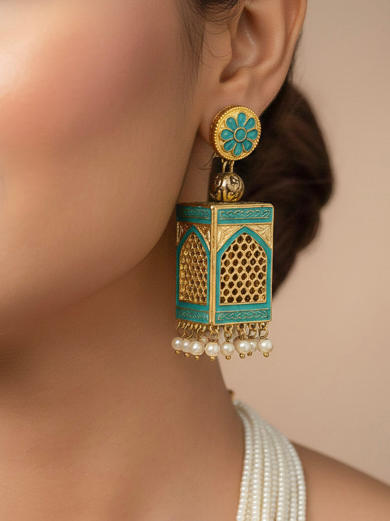 Close-up of a woman wearing an ornate traditional Mint Green Rajwadi gold Long jewellery set and earrings  with  Pearls and Meenakari. Festive Diwali outfit enhanced with a Rajwadi artificial necklace. Woman pairing a Rajwadi necklace with a red saree. Close-up of enamel work in Meenakari artificial wedding jewelry.