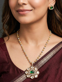 Woman wearing the Jiya emerald green American Diamond pendant set with earrings