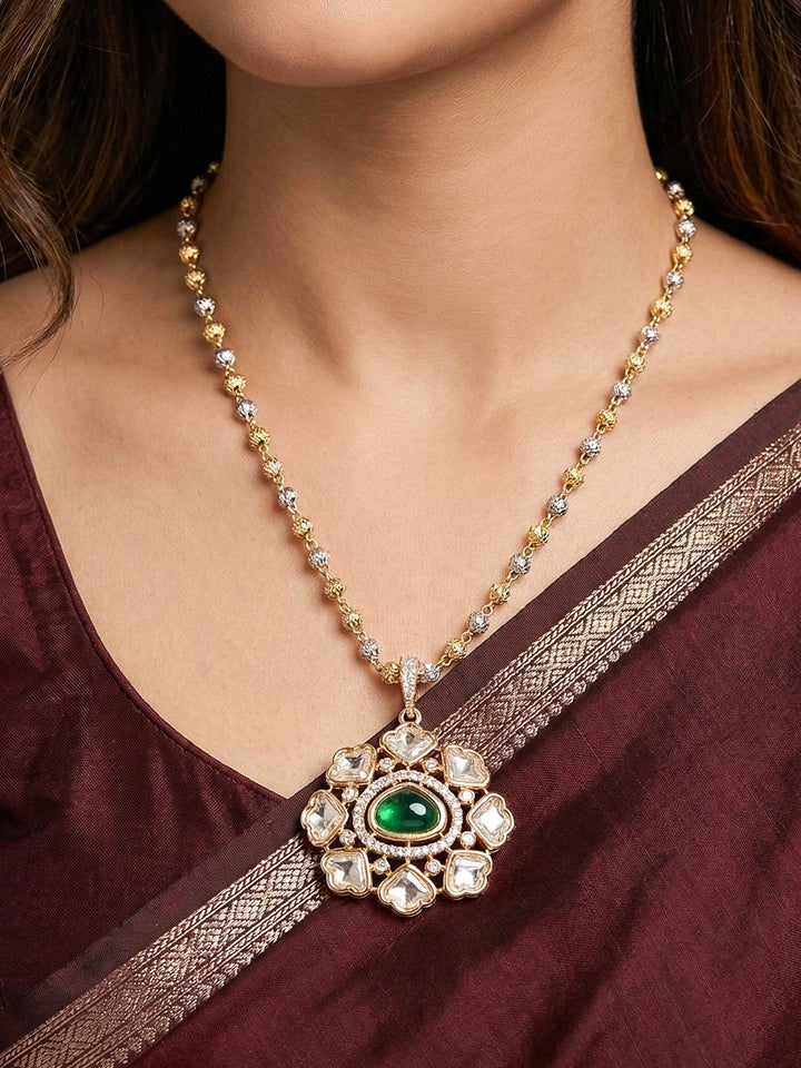 Close-up of a woman wearing an ornate Indo-western Green (Carat Polish) Diamond Pendant set and earrings with American Diamonds, Colored Stones and Moissanite. Elegant festive look with a high-quality imitation American diamond Pendant set. Close-up of high-quality  artificial American Diamond necklace craftsmanship.