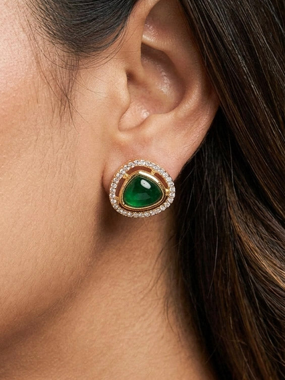 Close-up of a woman wearing an ornate Indo-western Green (Carat Polish) Diamond Pendant set and earrings with American Diamonds, Colored Stones and Moissanite. Elegant festive look with a high-quality imitation American diamond Pendant set. Close-up of high-quality  artificial American Diamond necklace craftsmanship.
