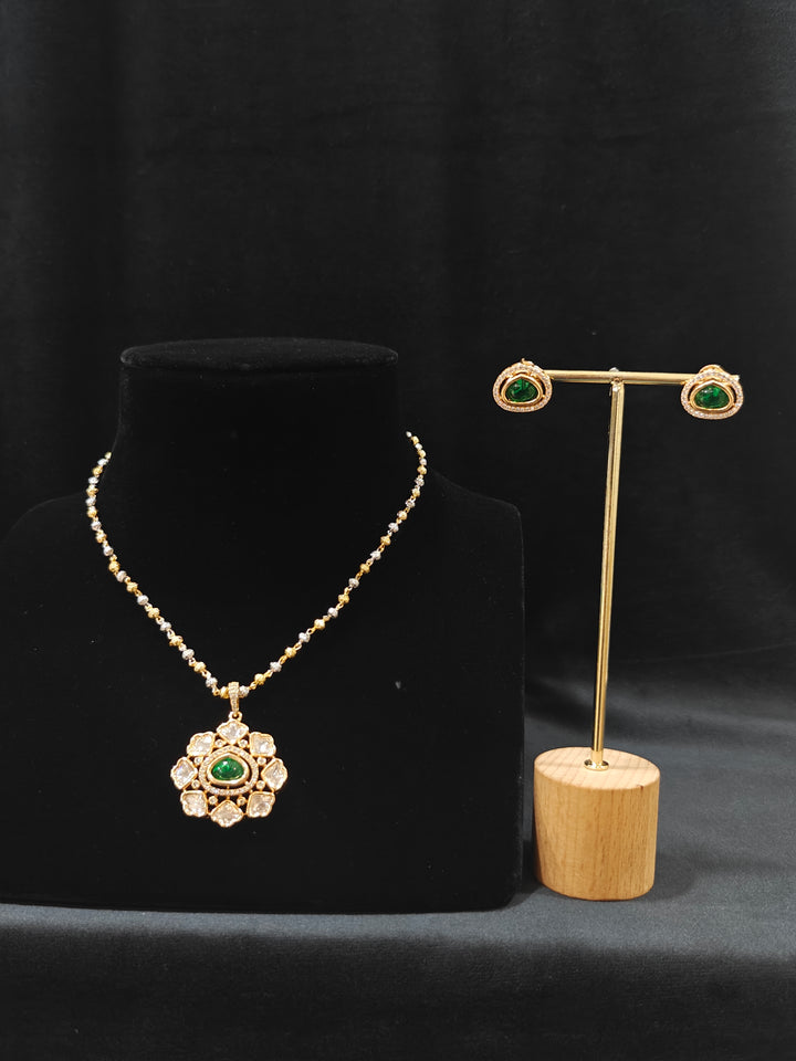Close-up of an ornate Indo-western Green (Carat Polish) Diamond Pendant set and earrings with American Diamonds, Colored Stones and Moissanite. Elegant festive look with a high-quality imitation American diamond Pendant set. Close-up of high-quality  artificial American Diamond necklace craftsmanship.