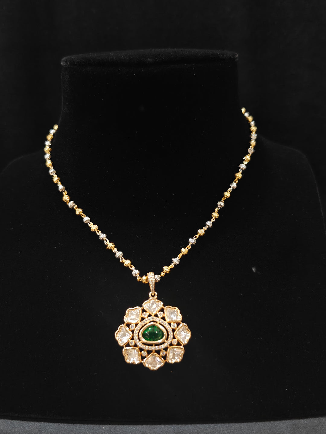 Close-up of an ornate Indo-western Green (Carat Polish) Diamond Pendant set and earrings with American Diamonds, Colored Stones and Moissanite. Elegant festive look with a high-quality imitation American diamond Pendant set. Close-up of high-quality  artificial American Diamond necklace craftsmanship.
