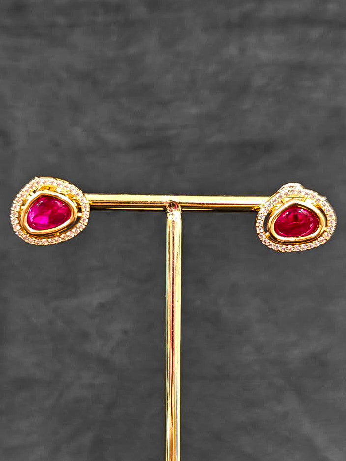 Close-up of an ornate Indo-western Ruby Pink (Carat Polish) Diamond Pendant set and earrings with American Diamonds, Colored Stones and Moissanite. Elegant festive look with a high-quality imitation American diamond Pendant set. Close-up of high-quality  artificial American Diamond necklace craftsmanship.