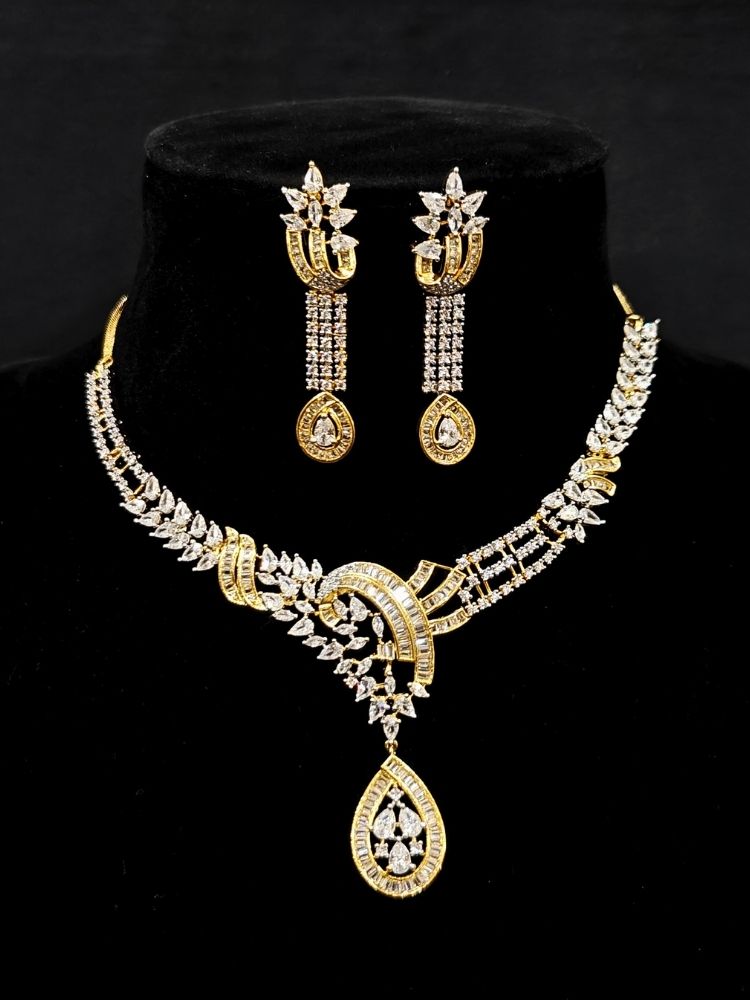 Close-up of an ornate Western (Dual Tone) Gold & Silver Collar jewellery set and earrings with American Diamond. Party wear outfit completed with a lightweight American diamond necklace. Close-up of a cocktail party look featuring a premium American diamond necklace.