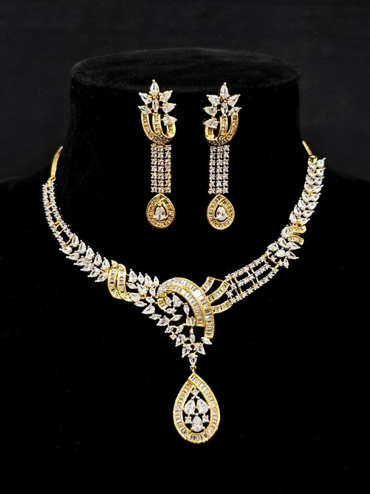 Close-up of an ornate Western (Dual Tone) Gold & Silver Collar jewellery set and earrings with American Diamond. Party wear outfit completed with a lightweight American diamond necklace. Close-up of a cocktail party look featuring a premium American diamond necklace.