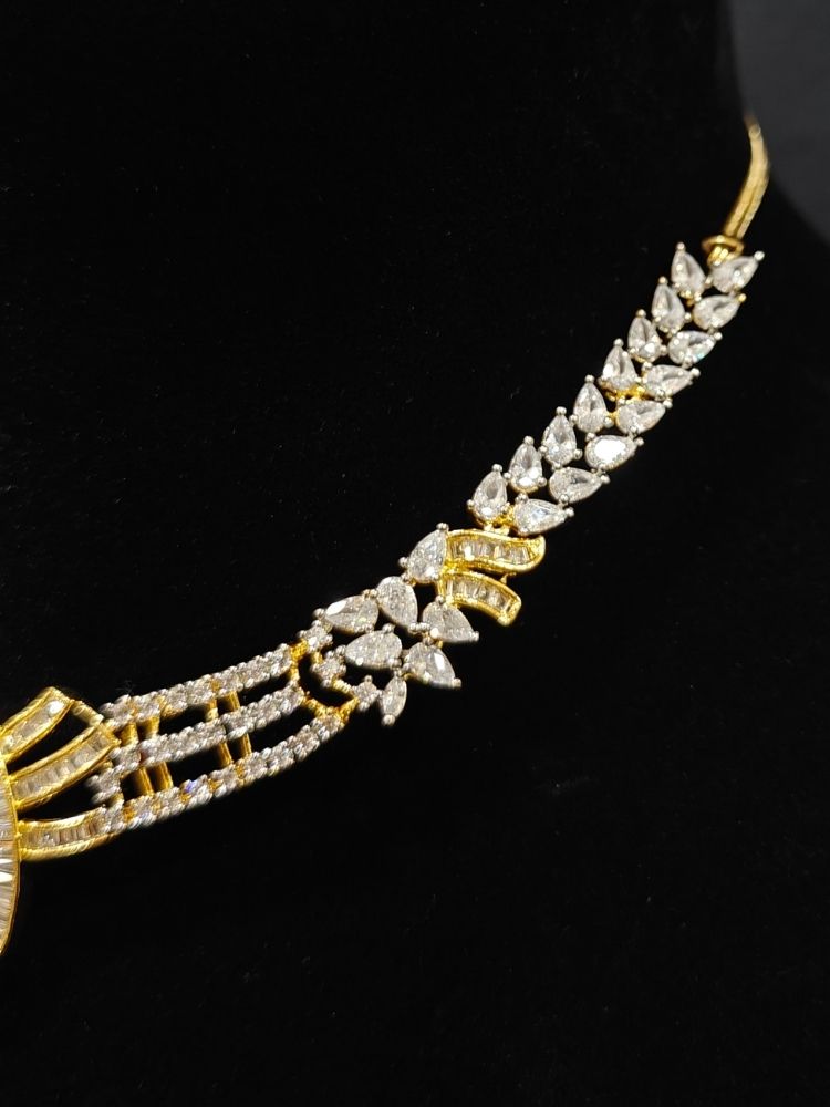 Close-up of an ornate Western (Dual Tone) Gold & Silver Collar jewellery set and earrings with American Diamond. Party wear outfit completed with a lightweight American diamond necklace. Close-up of a cocktail party look featuring a premium American diamond necklace.