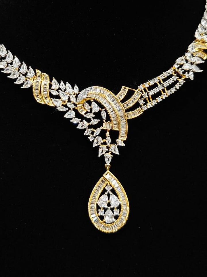 Close-up of an ornate Western (Dual Tone) Gold & Silver Collar jewellery set and earrings with American Diamond. Party wear outfit completed with a lightweight American diamond necklace. Close-up of a cocktail party look featuring a premium American diamond necklace.