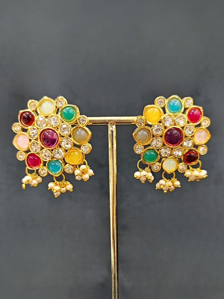 Close-up of an ornate traditional (Gold Polish) Choker jewellery set and earrings with American Damonds,  Multi-Colored Stones and Pearls. Mehendi ceremony look completed with a handcrafted Colored Stone jewelry set. Festive Diwali outfit paired with a colorful  Colored Stones necklace.