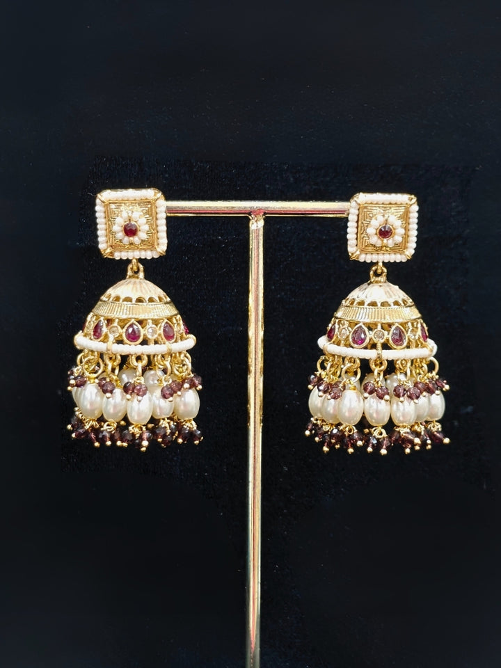 Close-up of an ornate traditional Purple Rajwadi gold Long jewellery set and earrings with Pearls, Crystal beads, American Diamonds, Colored Stones and Meenakari work.  Elegant Anarkali look paired with a traditional Rajwadi artificial necklace. Wedding guest styling a Rajwadi artificial necklace. 