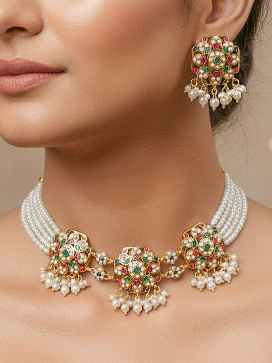 Close-up of a woman wearing an ornate traditional Navratan Choker jadau gold jewellery set and  jadau earrings with Pearl and Navratan Colored Stone. Mehendi function outfit styled with a lightweight Jadau necklace. Festive celebration look featuring a Jadau artificial necklace.