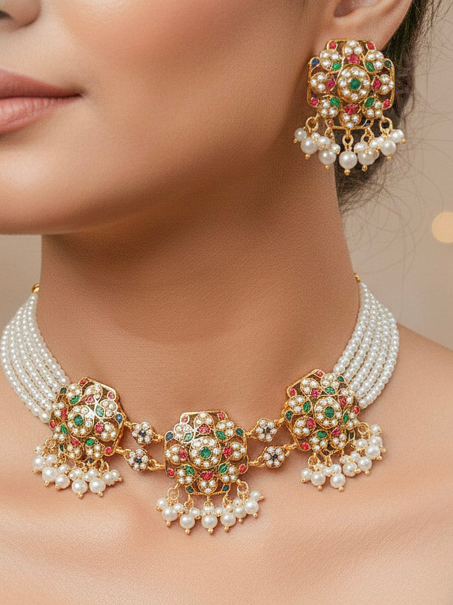 Close-up of a woman wearing an ornate traditional Navratan Choker jadau gold jewellery set and  jadau earrings with Pearl and Navratan Colored Stone. Mehendi function outfit styled with a lightweight Jadau necklace. Festive celebration look featuring a Jadau artificial necklace.
