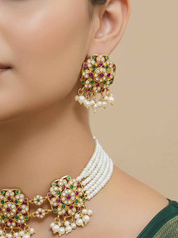 Close-up of a woman wearing an ornate traditional Ruby Pink and Green Choker jadau gold jewellery set and  jadau earrings with Pearl and Colored Stone. Mehendi function outfit styled with a lightweight Jadau necklace. Festive celebration look featuring a Jadau artificial necklace.