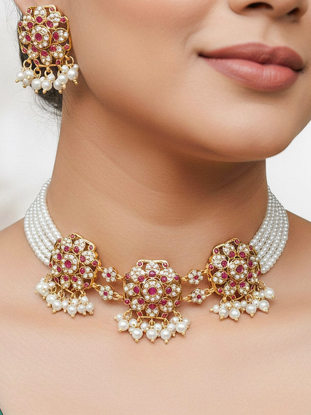 Close-up of a woman wearing an ornate handmade jadau jewelry set and earrings with pink colored stones. This is a perfect jadau jewelry set for weddings, festivals and more. Can also be worn as bridal jadau jewelry for indian weddings. 