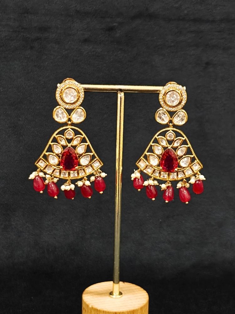 Close-up of an ornate traditional (Gold Polish) Layered Multi-Color jewellery set and earrings with Polki, American Diamond, Colored Stones and Tumble Beads. Woman styling a premium Polki imitation necklace for wedding celebrations. Festive celebration look completed with premium imitation Polki jewelry.