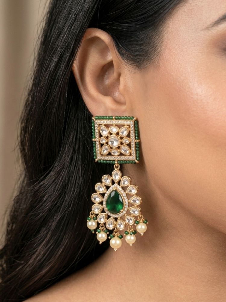 Close-up of a woman wearing an ornate traditional (Gold Polish) Dark Green Choker jewellery set and earrings and maangtikka with Polki, Pearl, Dark Green Colored Stones and Crystal Beads. Woman styling a premium Polki imitation necklace for wedding celebrations. Woman wearing a lightweight Polki jewelry set for long wedding functions.