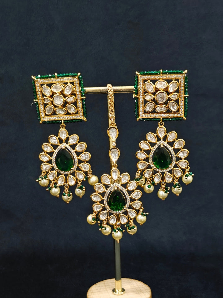 Close-up of an ornate traditional (Gold Polish) Dark Green Choker jewellery set and earrings and maangtikka with Polki, Pearl, Dark Green Colored Stones and Crystal Beads. Woman styling a premium Polki imitation necklace for wedding celebrations. Woman wearing a lightweight Polki jewelry set for long wedding functions.