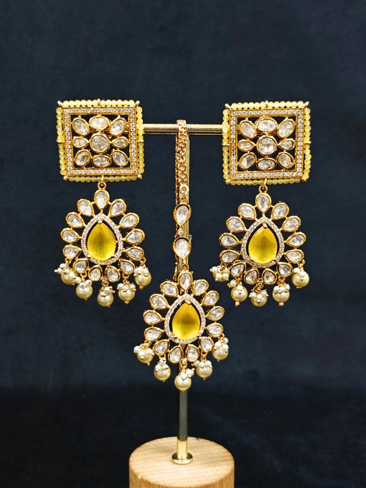 Close-up of an ornate traditional (Gold Polish) Yellow Choker jewellery set and earrings and maangtikka with Polki, Pearl, Yellow Colored Stones and Crystal Beads. Woman styling a premium Polki imitation necklace for wedding celebrations. Woman wearing a lightweight Polki jewelry set for long wedding functions.