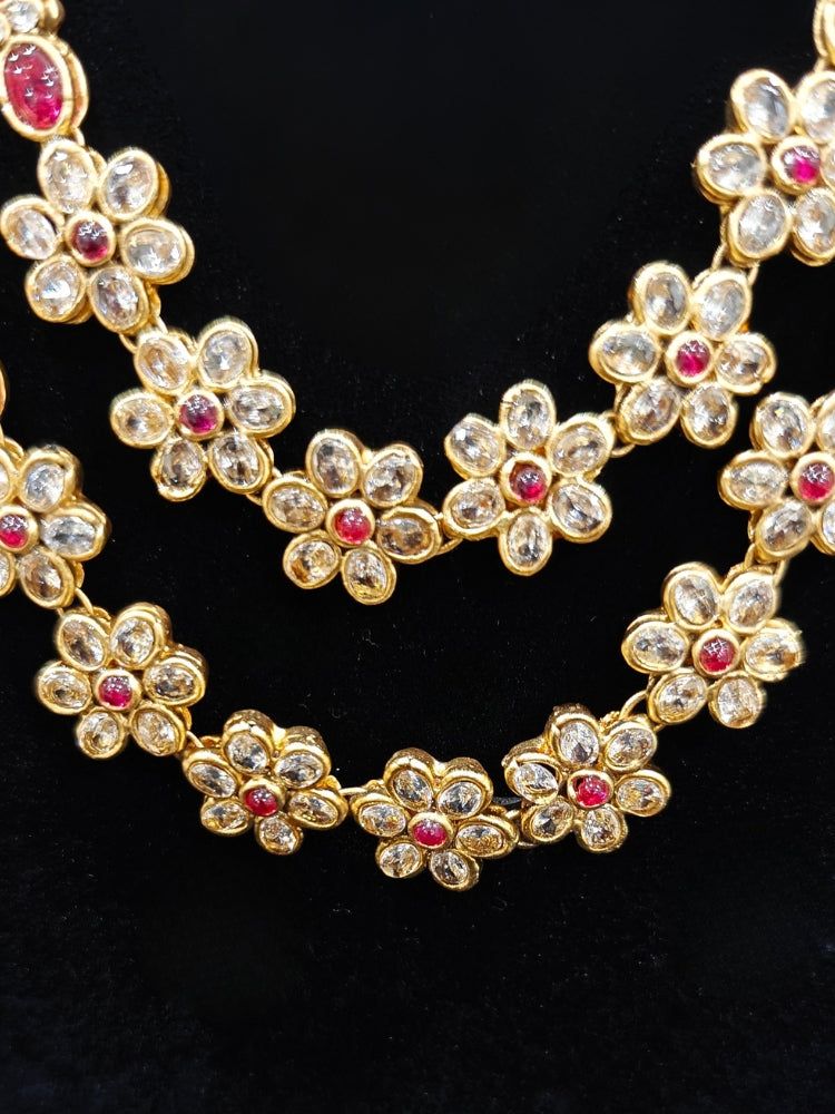 the Red Karuna Temple Necklace Set featuring a traditional gold Long necklace and matching earrings with Red colored stones, paired with a Saree—Saree look enhanced with a royal temple imitation necklace.