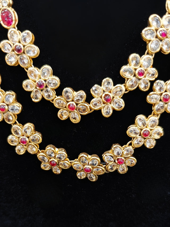 the Red Karuna Temple Necklace Set featuring a traditional gold Long necklace and matching earrings with Red colored stones, paired with a Saree—Saree look enhanced with a royal temple imitation necklace.