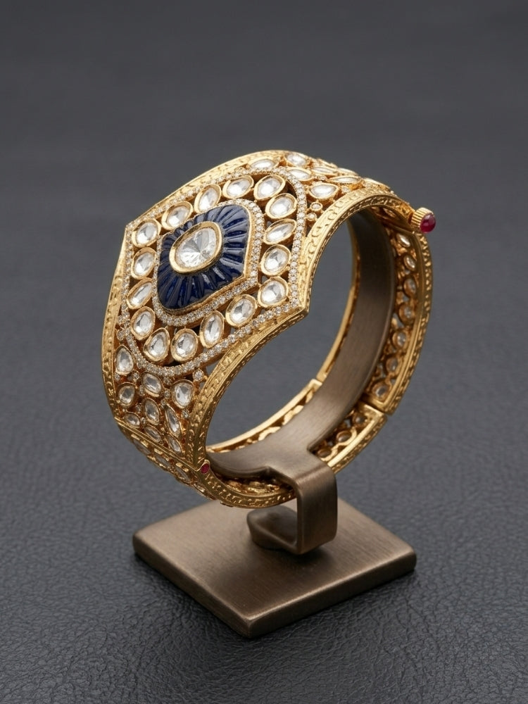 Close-up of an ornate traditional (Gold Polish) Navy Blue Bracelet with Polki, American Diamond and Navy Blue Colored Stone. Close-up of an anti-tarnish artificial Polki bracelet styled for wedding guests.Festive outfit paired with a premium imitation Polki bracelet in India.
