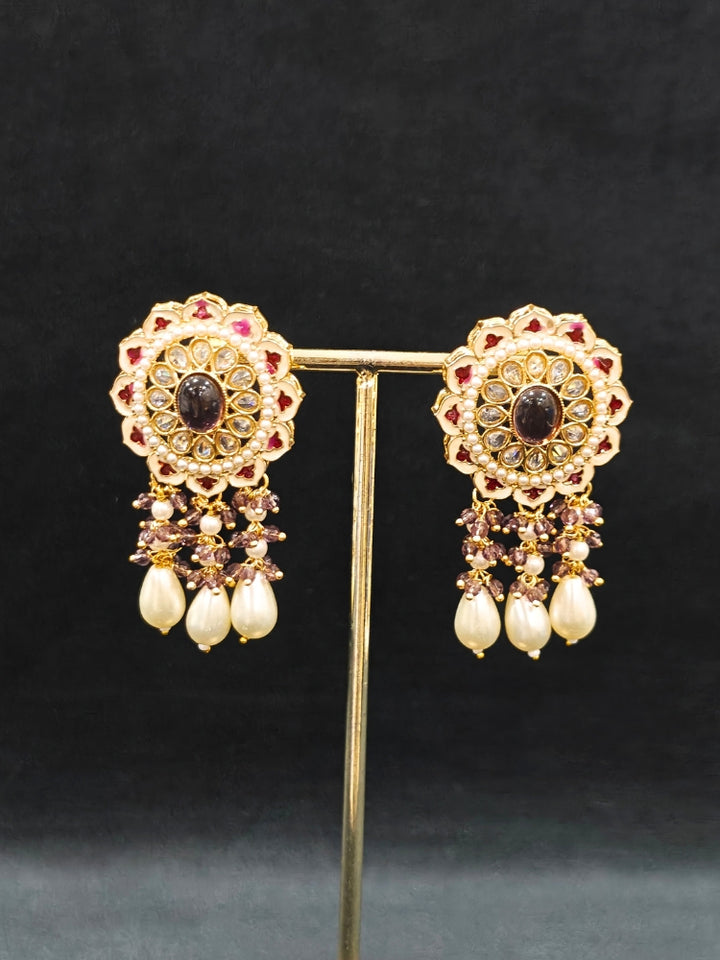 Close-up of an ornate traditional Lilac Rajwadi gold Long jewellery set and earrings with Pearls, Crystal beads, Tumble stones, American Diamonds, Colored Stones, Meenakari work and Pearls. Festive Diwali outfit enhanced with a Rajwadi artificial necklace. Royal wedding guest outfit featuring a Rajwadi necklace. Close-up of enamel work in Meenakari artificial wedding jewelry.
