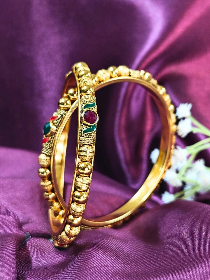 Close-up of an ornate traditional (Gold Polish) White Bangles Set. It’s comfortable and lightweight enough for everyday wear, and it also looks absolutely beautiful and elegant. The design is stylish, the finish is impressive, and it feels really pleasant to wear all day.