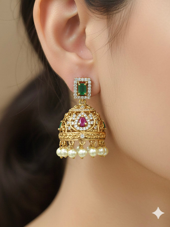 Close-up of a woman wearing an ornate traditional American Diamond gold Green Choker jewellery set and earrings with  Colored Stones, American Diamond and Pearls. Close-up shot of a high-quality American diamond artificial necklace worn for festive celebrations. Bride wearing a sparkling American diamond necklace for her reception night.