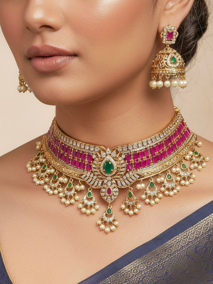 Close-up of a woman wearing an ornate traditional American Diamond gold Pink Choker jewellery set and earrings with  Colored Stones, American Diamond and Pearls. Close-up shot of a high-quality American diamond artificial necklace worn for festive celebrations. Bride wearing a sparkling American diamond necklace for her reception night.