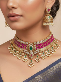 Woman wearing the Kavira pink choker necklace set with gold-tone floral centre motif