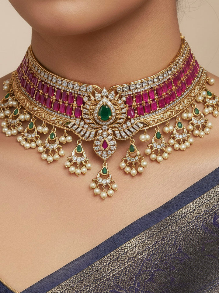 Close-up of a woman wearing an ornate traditional American Diamond gold Pink Choker jewellery set and earrings with  Colored Stones, American Diamond and Pearls. Close-up shot of a high-quality American diamond artificial necklace worn for festive celebrations. Bride wearing a sparkling American diamond necklace for her reception night.