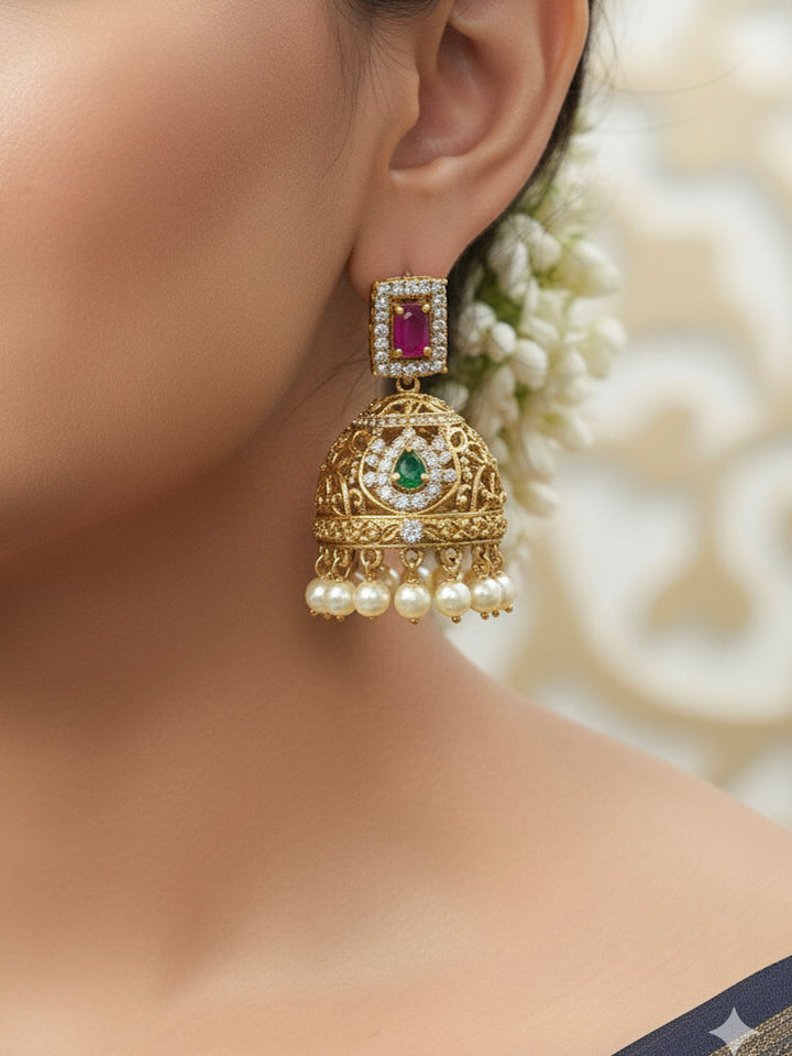 Close-up of a woman wearing an ornate traditional American Diamond gold Pink Choker jewellery set and earrings with  Colored Stones, American Diamond and Pearls. Close-up shot of a high-quality American diamond artificial necklace worn for festive celebrations. Bride wearing a sparkling American diamond necklace for her reception night.