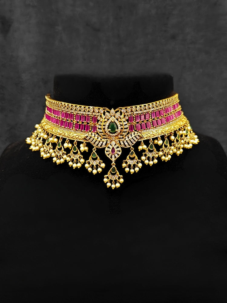 Close-up of an ornate traditional American Diamond gold Pink Choker jewellery set and earrings with  Colored Stones, American Diamond and Pearls. Close-up shot of a high-quality American diamond artificial necklace worn for festive celebrations. A sparkling American diamond necklace for her reception night.