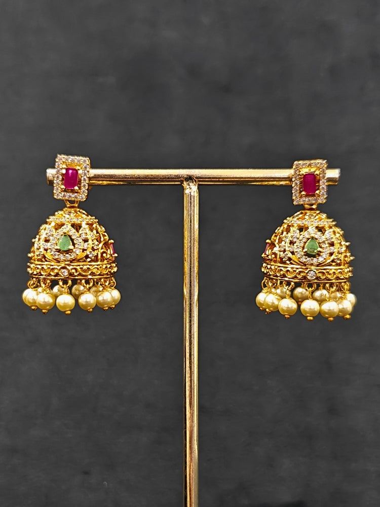 Close-up of an ornate traditional American Diamond gold Pink Choker jewellery set and earrings with  Colored Stones, American Diamond and Pearls. Close-up shot of a high-quality American diamond artificial necklace worn for festive celebrations. A sparkling American diamond necklace for her reception night.