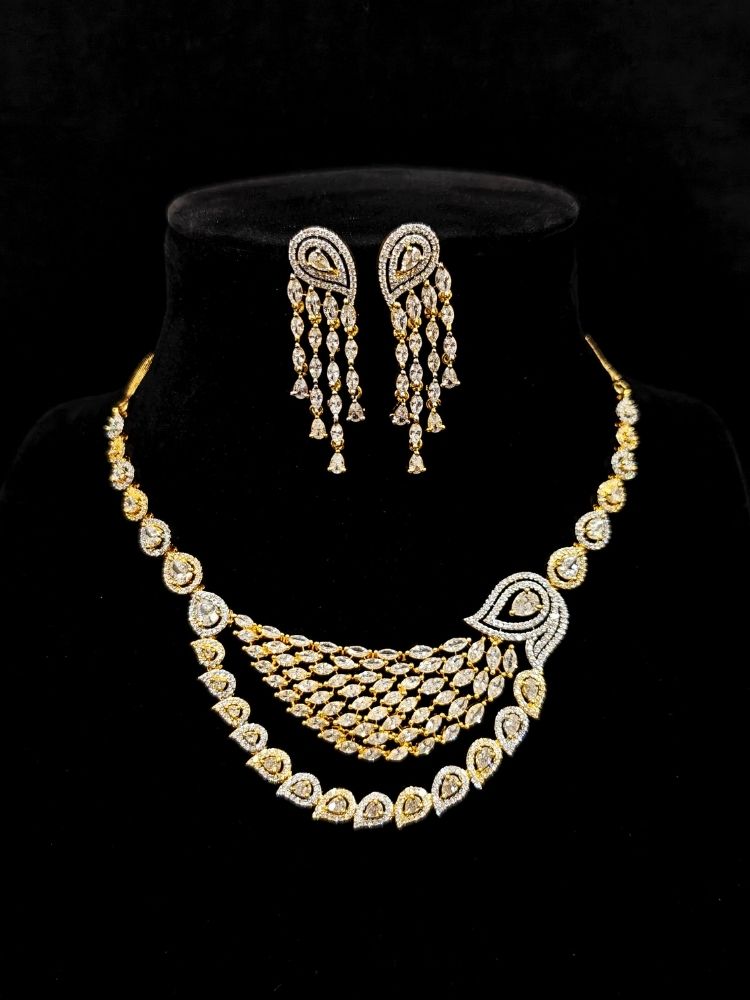 Close-up of an ornate Western (Dual Tone) Gold & Silver Collar jewellery set and earrings with American Diamond. Party wear outfit completed with a lightweight American diamond necklace. Close-up of a cocktail party look featuring a premium American diamond necklace.