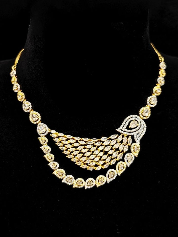 Close-up of an ornate Western (Dual Tone) Gold & Silver Collar jewellery set and earrings with American Diamond. Party wear outfit completed with a lightweight American diamond necklace. Close-up of a cocktail party look featuring a premium American diamond necklace.