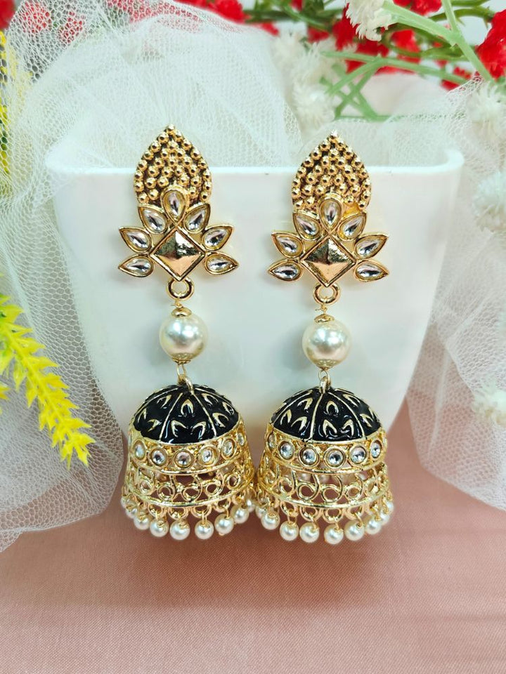  Kritika Black Earrings—large gold jhumkas featuring green meenakari work, pearl accents, kundan detailing, and a delicate floral motif. 