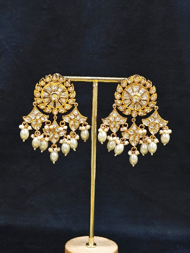 Close-up of an ornate traditional (Gold Polish) Long jewellery set and earrings with Polki and Pearls. Festive saree look completed with a Long Polki artificial jewelry set. Woman wearing trending Polki artificial jewelry for the wedding season in India.