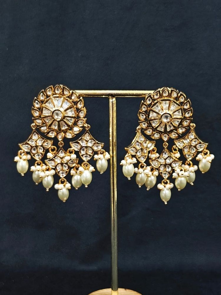 Close-up of an ornate traditional (Gold Polish) Long jewellery set and earrings with Polki and Pearls. Festive saree look completed with a Long Polki artificial jewelry set. Woman wearing trending Polki artificial jewelry for the wedding season in India.