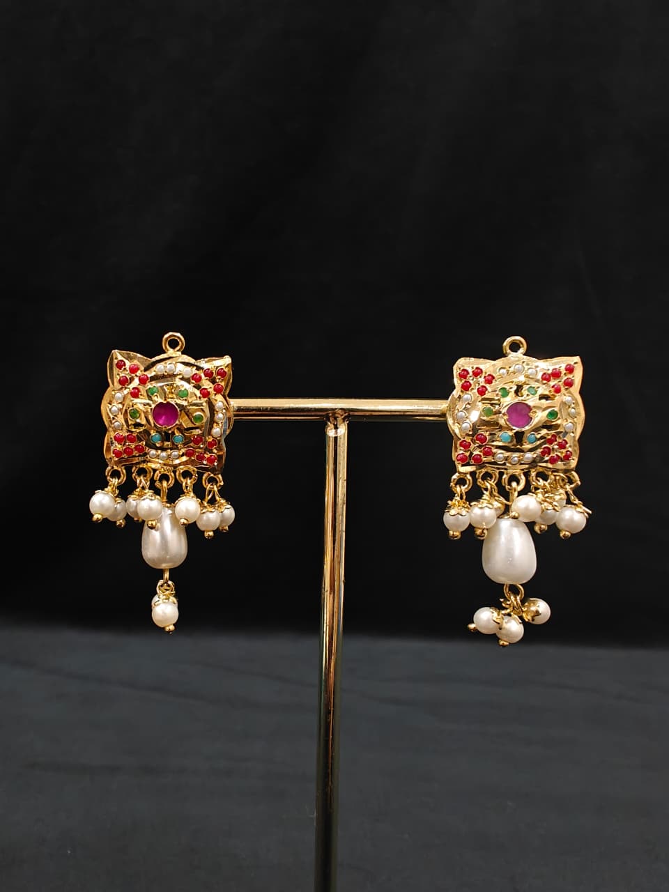 Close-up of an ornate traditional Multi-color jadau gold Pendant set and jadau earrings with pearls, Beads and Color Stone. Elegant look featuring a luxury Jadau artificial Pendant set. Festive look completed with a handcrafted Jadau Pendant.