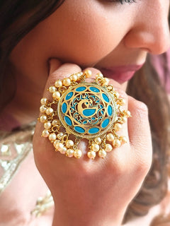 Close-up of a woman wearing an ornate traditional (Gold Polish) Blue Ring with Pearls and Meenakari. Woman styling a premium imitation Pearl ring with festive attire. Bridal mehendi outfit paired with a luxury artificial Pearl ring.