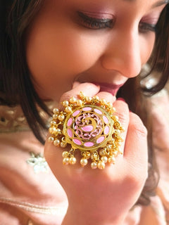 Close-up of a woman wearing an ornate traditional (Gold Polish) Pink Ring with Pearls and Meenakari. Woman styling a premium imitation Pearl ring with festive attire. Bridal mehendi outfit paired with a luxury artificial Pearl ring.
