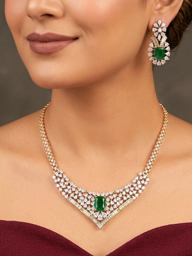 Close-up of a woman wearing an ornate Western (Silver Polish) Green Collar jewellery set and earrings with Green Colored Stone and American Diamond. Woman styling a statement American diamond necklace with an off-shoulder gown for a reception. Party wear outfit completed with a lightweight American diamond necklace.