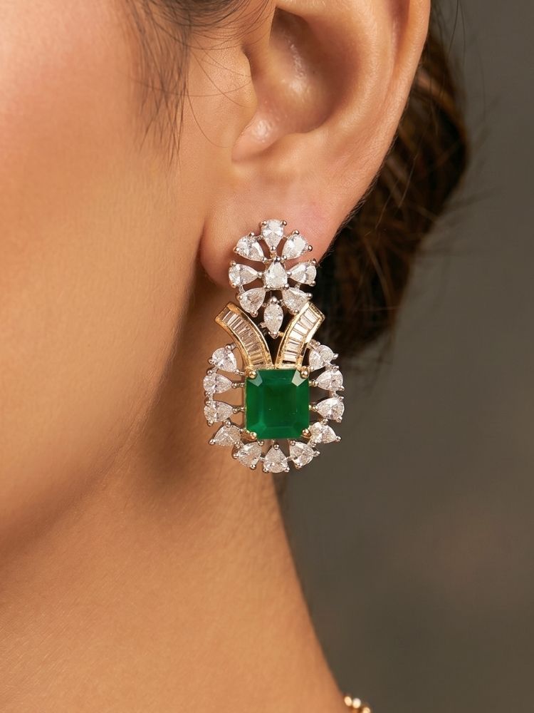 Close-up of a woman wearing an ornate Western (Silver Polish) Green Collar jewellery set and earrings with Green Colored Stone and American Diamond. Woman styling a statement American diamond necklace with an off-shoulder gown for a reception. Party wear outfit completed with a lightweight American diamond necklace.