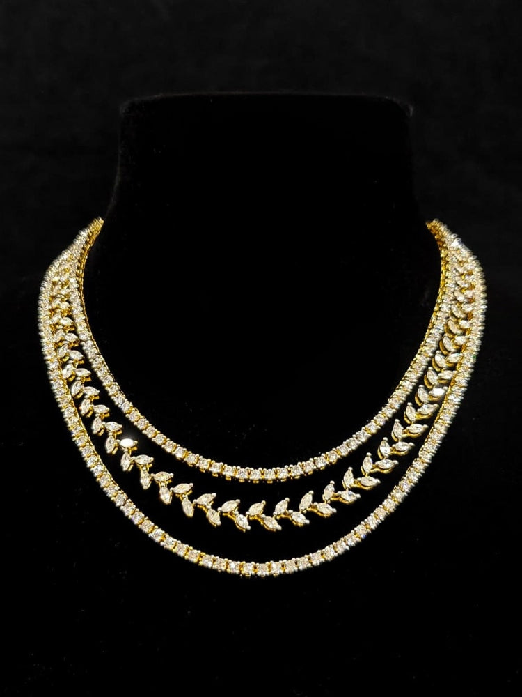 Close-up of an ornate Indo-Western American Diamond gold Layered Collar jewellery set and earrings with American Diamond. Close-up of a cocktail party look featuring a premium American diamond necklace. Party wear outfit completed with a lightweight American diamond necklace.