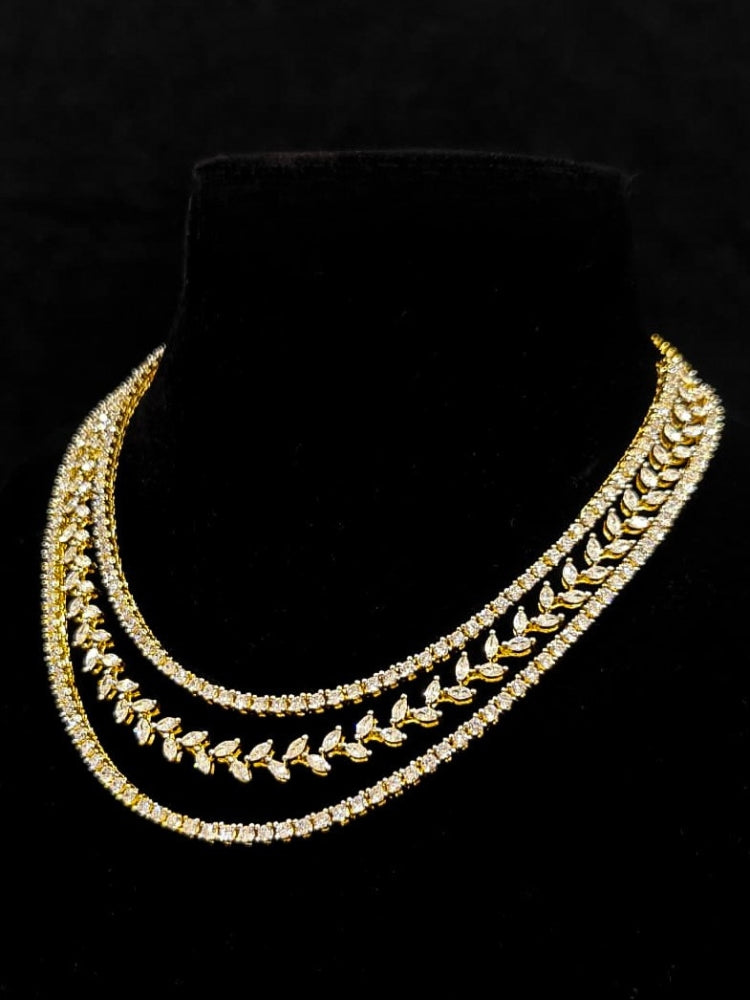 Close-up of an ornate Indo-Western American Diamond gold Layered Collar jewellery set and earrings with American Diamond. Close-up of a cocktail party look featuring a premium American diamond necklace. Party wear outfit completed with a lightweight American diamond necklace.