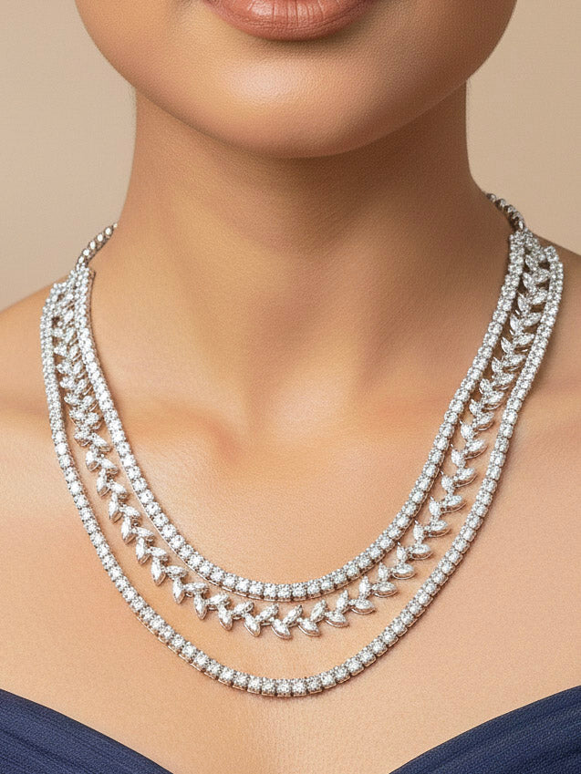 Close-up of a women wearing an ornate Indo-Western American Diamond Silver Layered Collar jewellery set and earrings with American Diamond. Close-up of a cocktail party look featuring a premium American diamond necklace. Party wear outfit completed with a lightweight American diamond necklace.