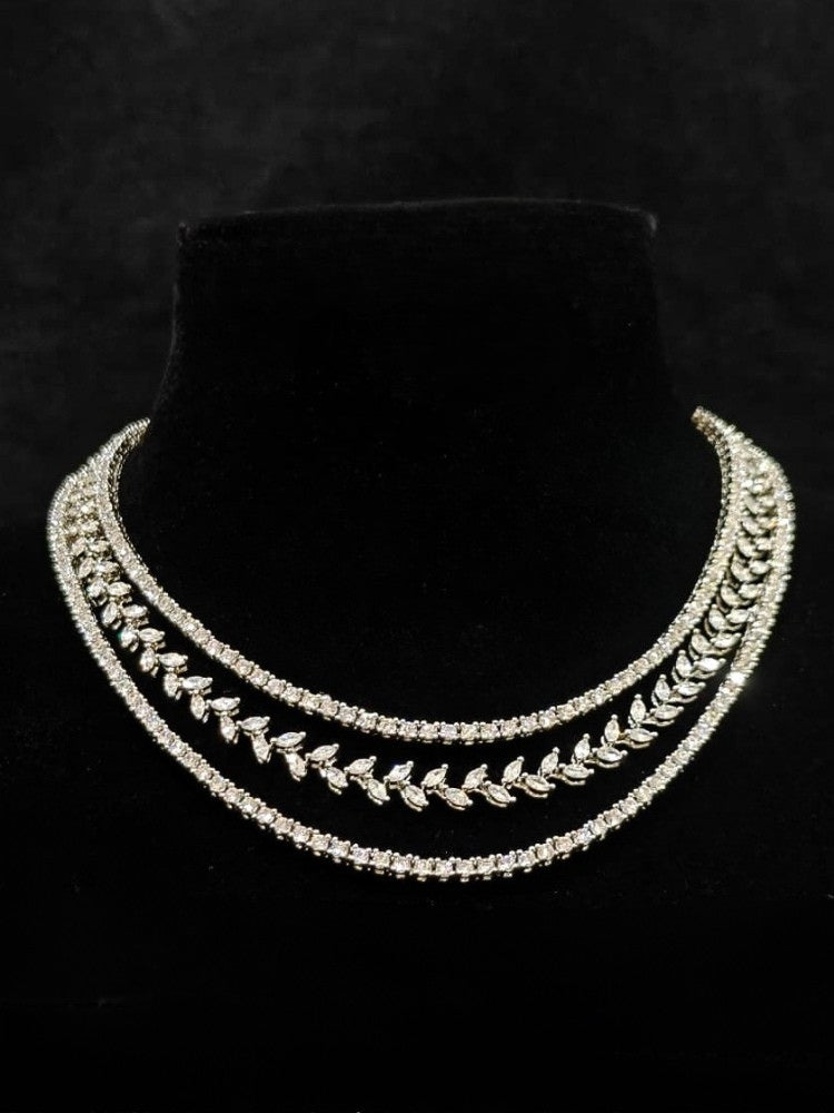 Close-up of an ornate Indo-Western American Diamond Silver Layered Collar jewellery set and earrings with American Diamond. Close-up of a cocktail party look featuring a premium American diamond necklace. Party wear outfit completed with a lightweight American diamond necklace.