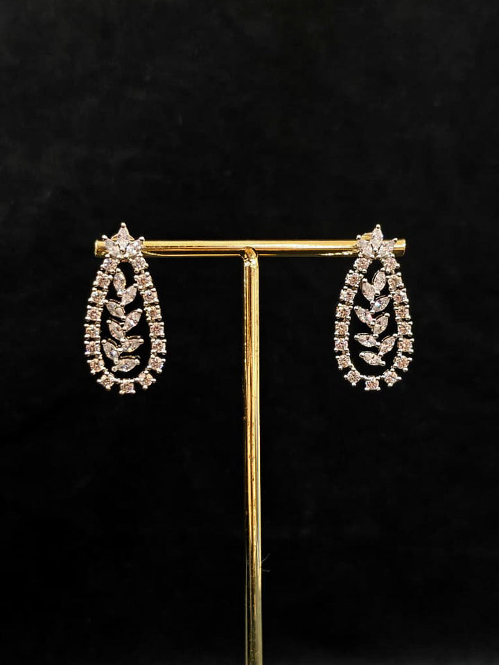 Close-up of an ornate Indo-Western American Diamond Silver Layered Collar jewellery set and earrings with American Diamond. Close-up of a cocktail party look featuring a premium American diamond necklace. Party wear outfit completed with a lightweight American diamond necklace.
